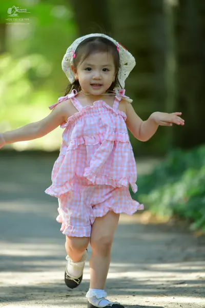 Dancesport competitor: Single child: pink and white gingham sleeveless ruffled romper with a matching h