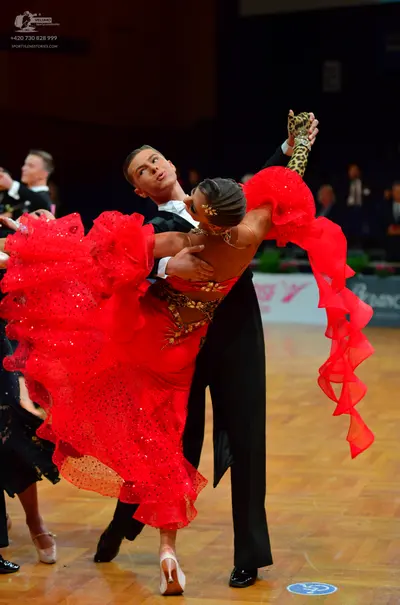 Dancesport competitor: Male dancer: black formal suit with a white shirt and black bow tie