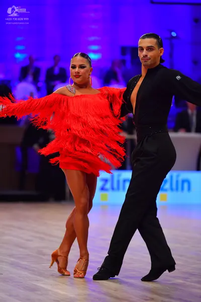 Dancesport competitor: Male dancer: black long-sleeved Latin shirt and black trousers
