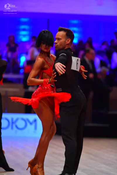Dancesport competitor: Male dancer: black long-sleeved shirt and black trousers