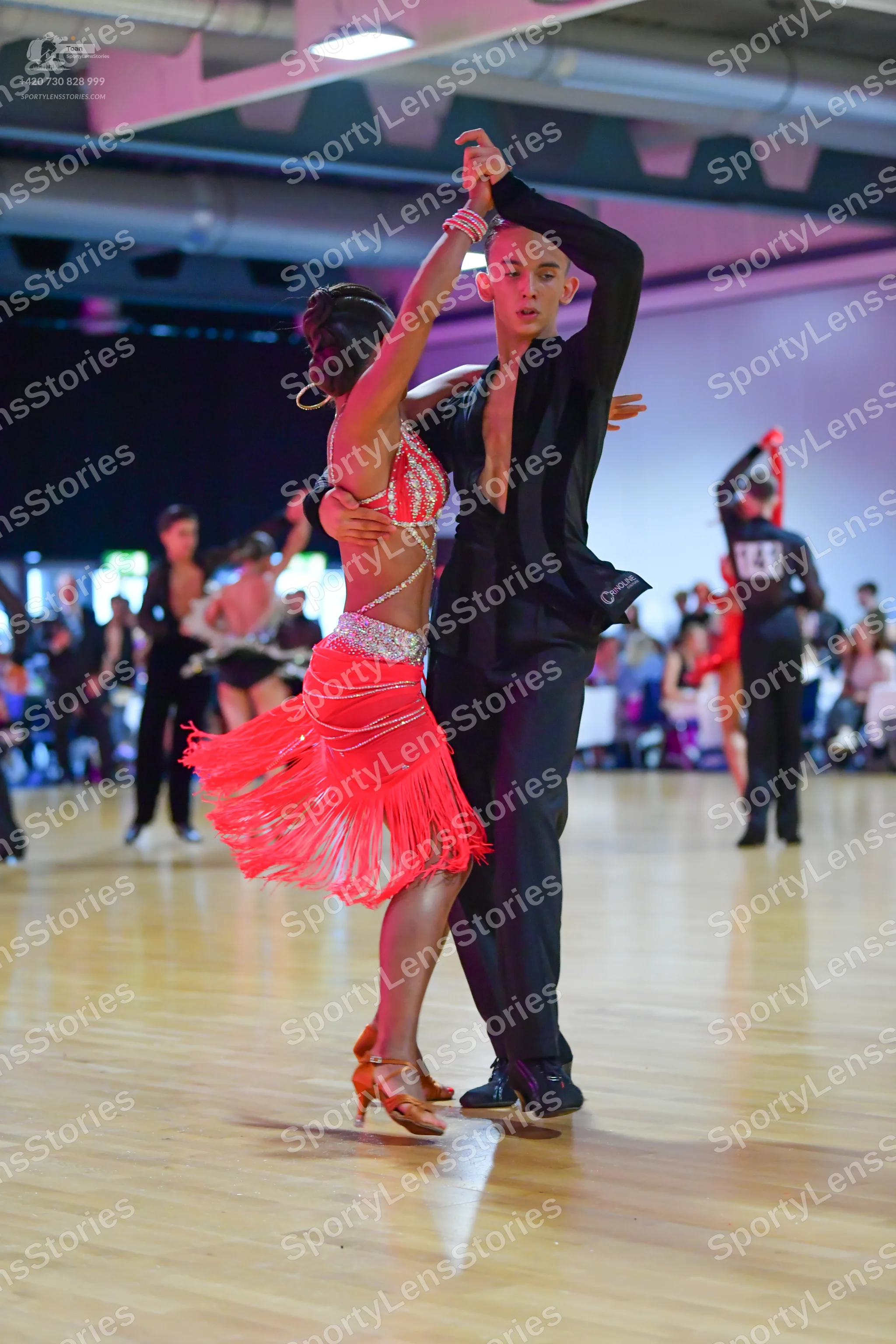 Dancesport competitor: Male dancer: black suit with long sleeves and black trousers