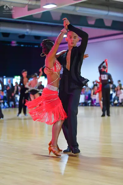 Dancesport competitor: Male dancer: black suit with long sleeves and black trousers