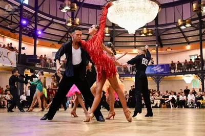 Dancesport competitor #145: Male dancer (center-left): black jacket, white shirt, and black trousers