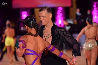 Dancesport competitor: Male dancer: black, semi-sheer long-sleeved shirt with subtle patterns