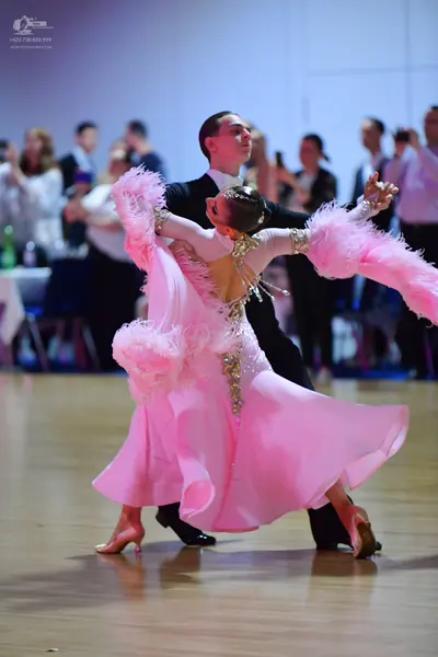 Dancesport competitor: Male dancer: black suit with a white shirt and black bowtie