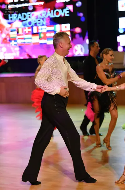 Dancesport competitor: ** Black suit with sequin lapels and trousers