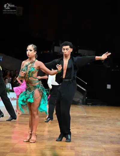 Dancesport competitor: Male dancer: black long-sleeved shirt and black trousers