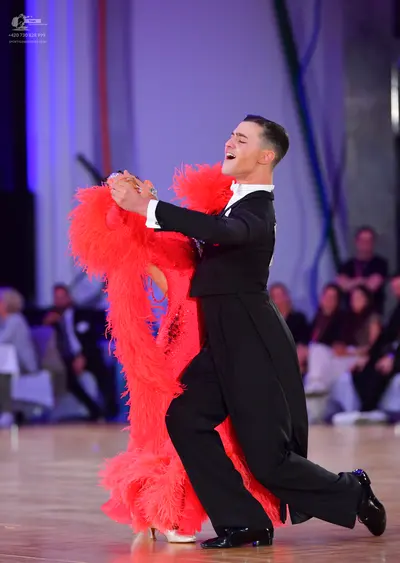 Dancesport competitor: Male dancer: black suit with a white shirt