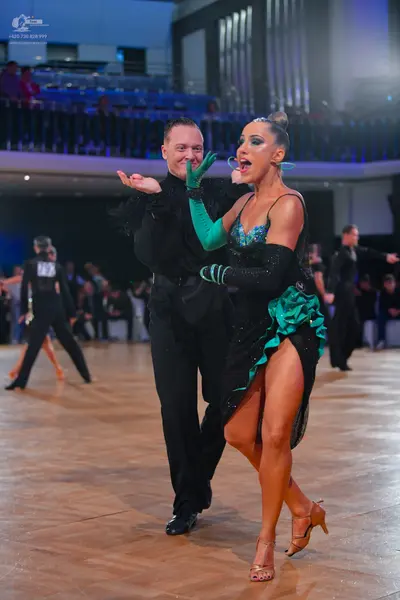 Dancesport competitor #213: Main female dancer: black latin dress with a teal sequined bodice and teal ruffl