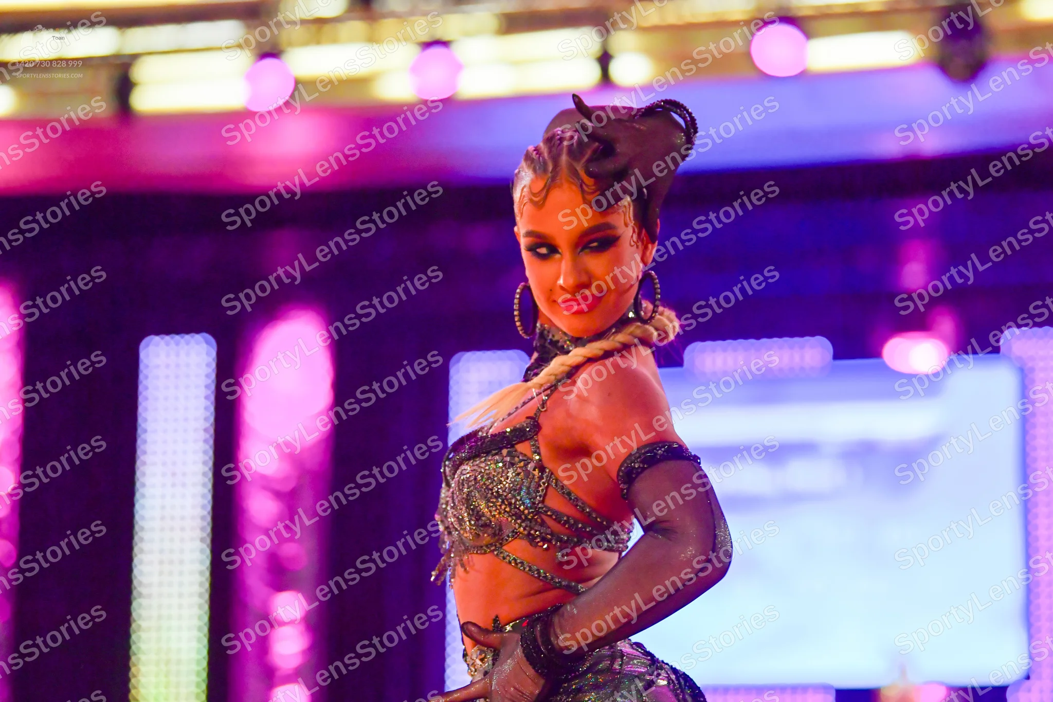Dancesport competitor: Female dancer: black/dark-colored Latin dance costume with silver sequin embelli