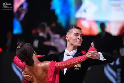 Dancesport competitor: Male dancer: black suit with white shirt and white bowtie