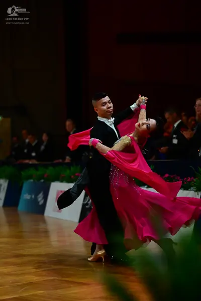Dancesport competitor: Male dancer: black suit with a white shirt and a white bowtie