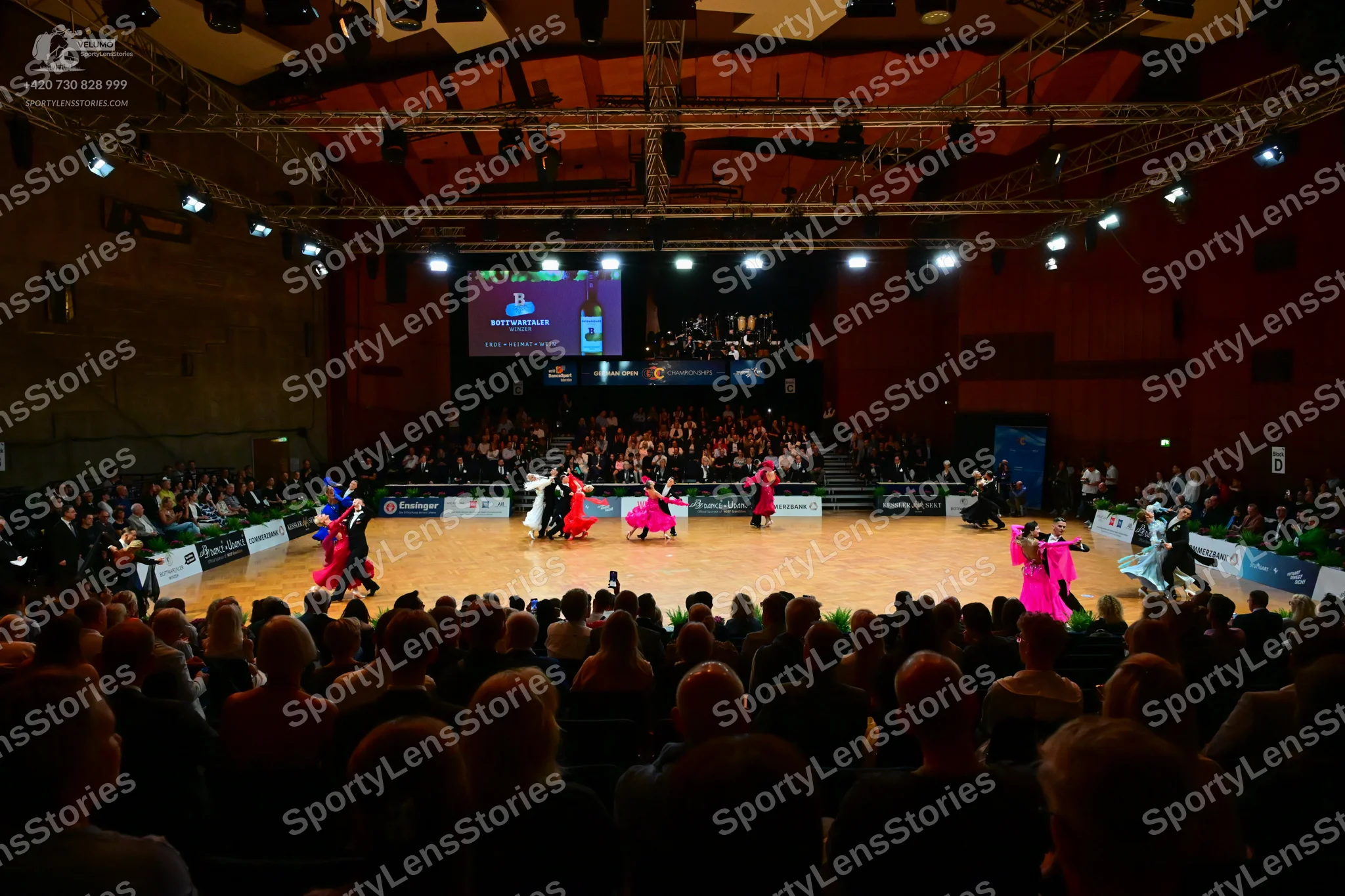Dancesport competitor: Male dancers: several in black suits; one in a white shirt or jacket with black