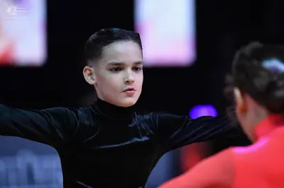 Dancesport competitor: Male dancer: black long-sleeved turtleneck top