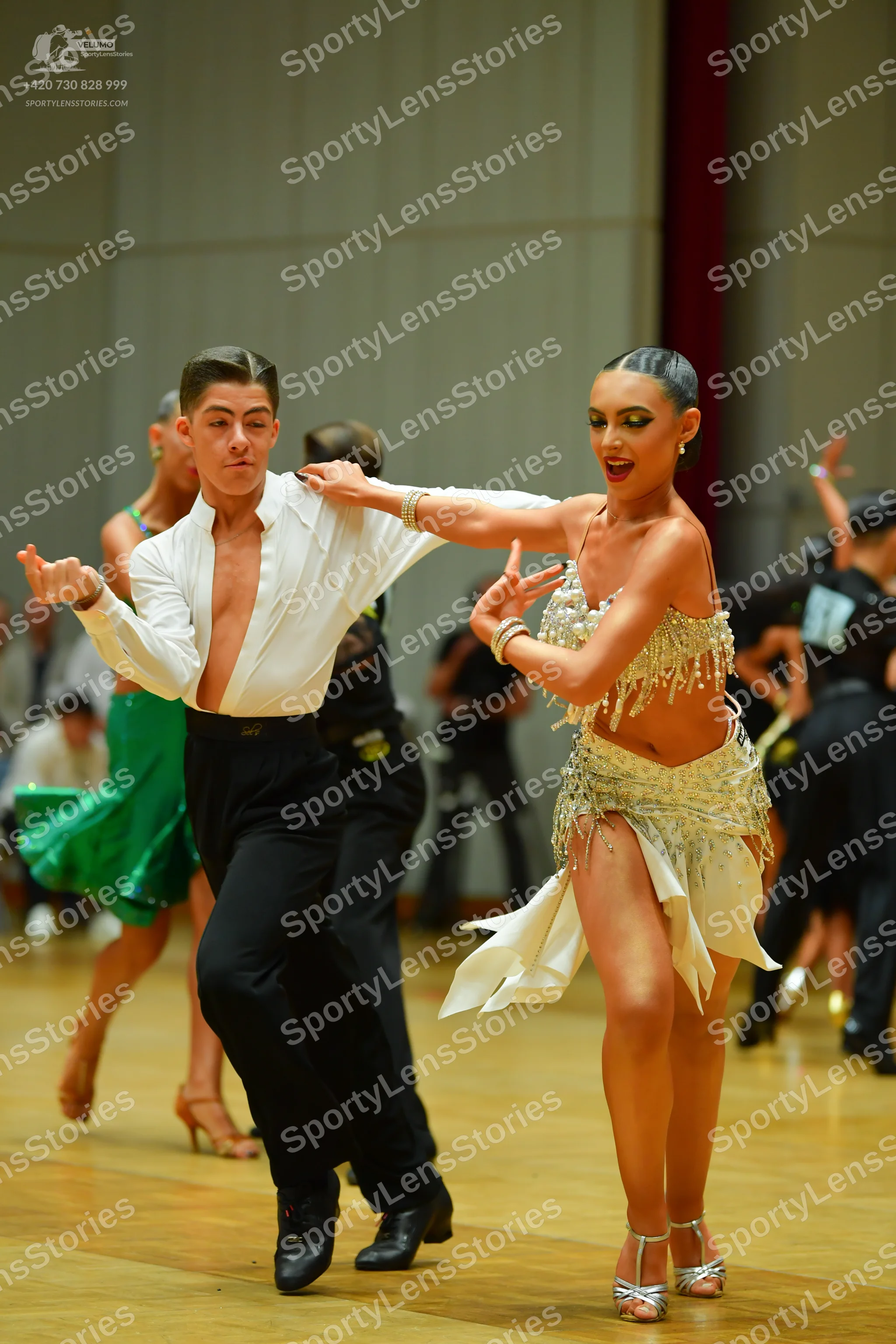 Dancesport competitor: Male dancer: white long-sleeved unbuttoned shirt and black trousers