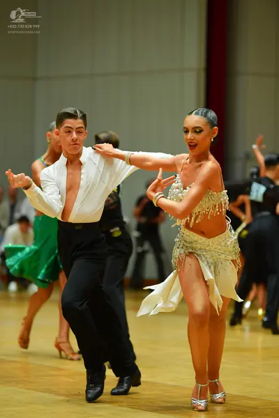 Dancesport competitor: Male dancer: white long-sleeved unbuttoned shirt and black trousers