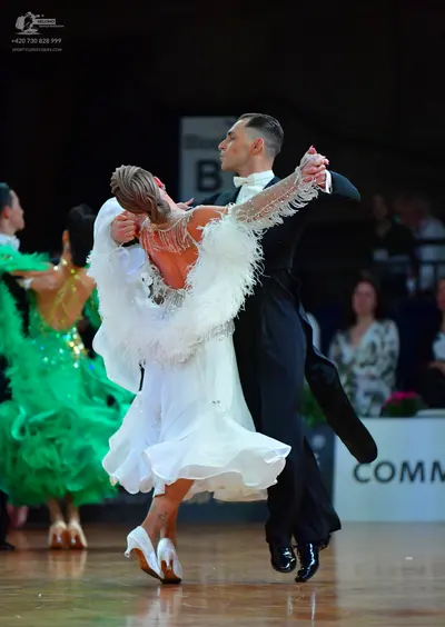 Dancesport competitor: Male dancer: black suit with white shirt and white bow tie