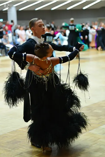 Dancesport competitor #15: Male dancer: black ballroom suit with a white shirt and white bowtie