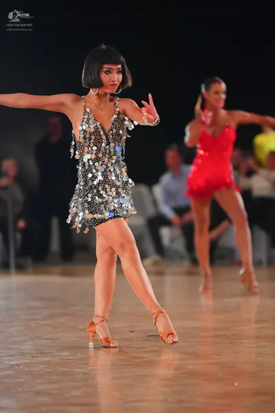 Dancesport competitor: Female dancer 1: silver Latin dress with large sequins and spaghetti straps, wea