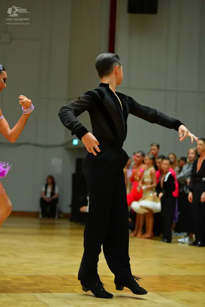 Dancesport competitor: Male dancer: black long-sleeved shirt and black trousers
