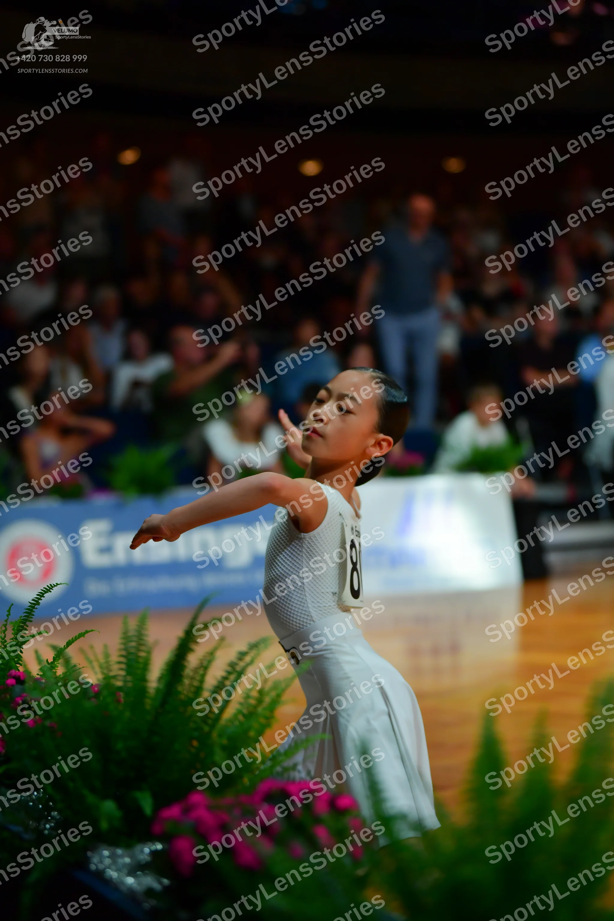 Dancesport competitor: Female dancer: white dress with a full skirt