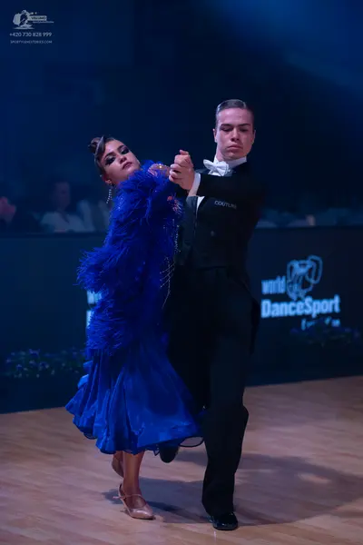 Dancesport competitor: Male dancer: black suit with a white shirt and white bow tie