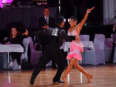 Dancesport competitor #601: Male dancer: black long-sleeved shirt with silver sequins on the shoulders and b