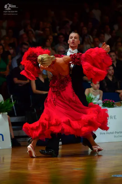 Dancesport competitor: Male dancer: black suit with a white shirt and white bow tie
