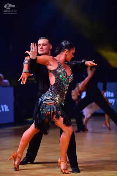 Dancesport competitor: Male dancer: black long-sleeved shirt and black trousers