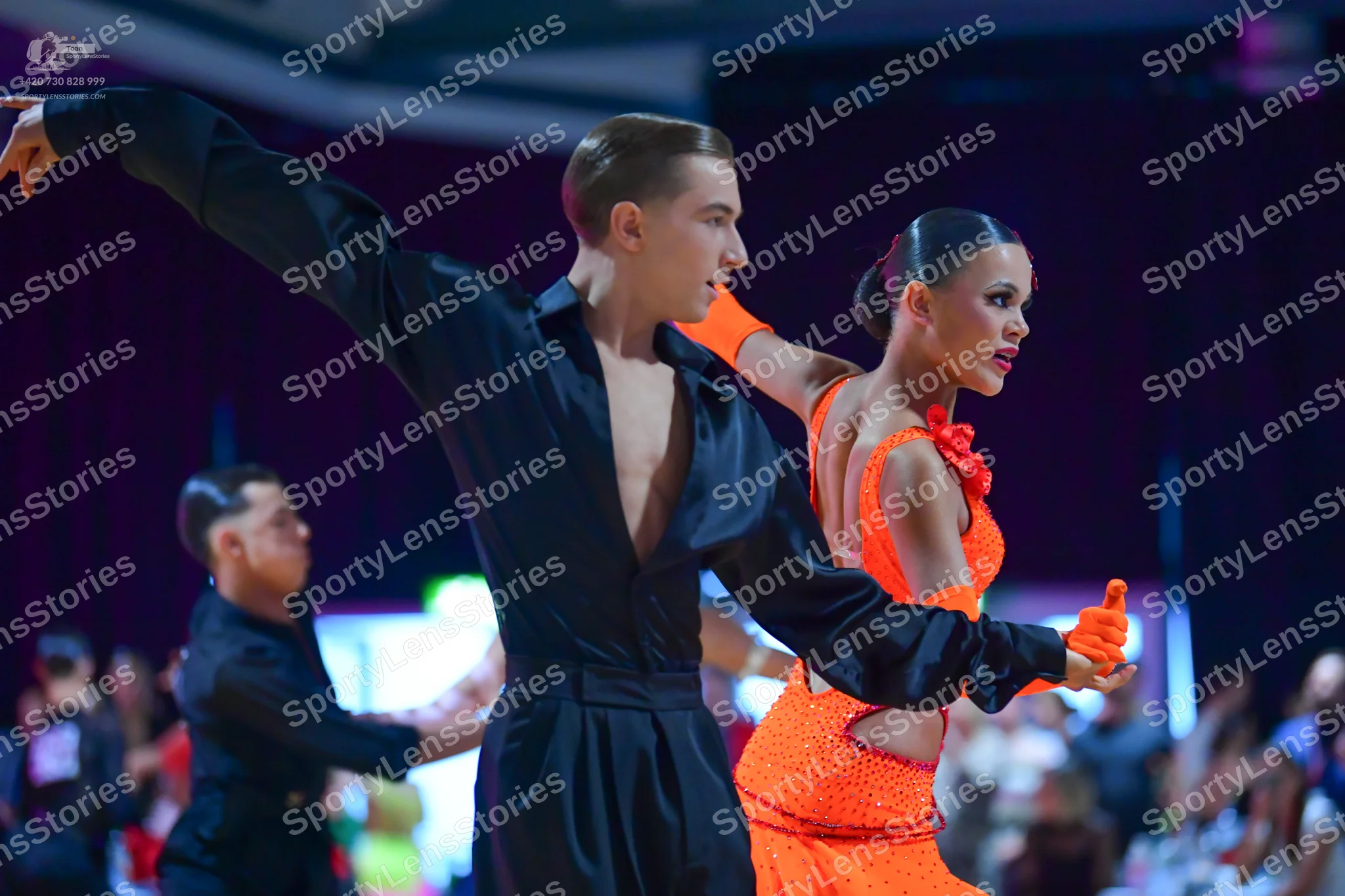 Dancesport competitor: Male dancer: black satin long-sleeved shirt with a deep V-neck and matching blac