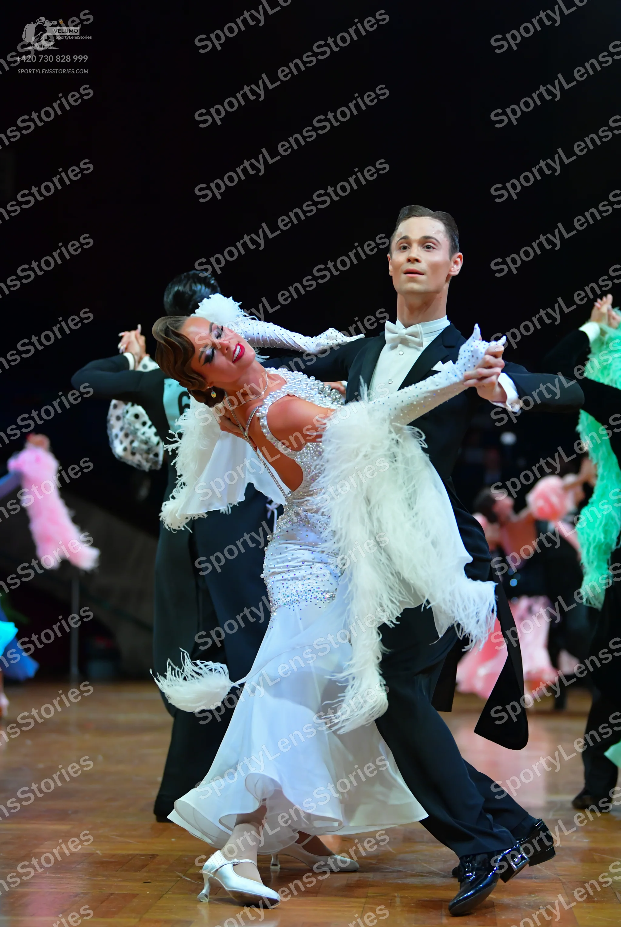 Dancesport competitor: Male dancer: black formal tailsuit with a white shirt and white bow tie