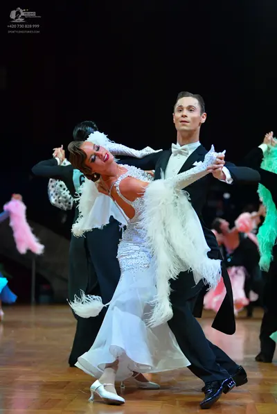 Dancesport competitor: Male dancer: black formal tailsuit with a white shirt and white bow tie