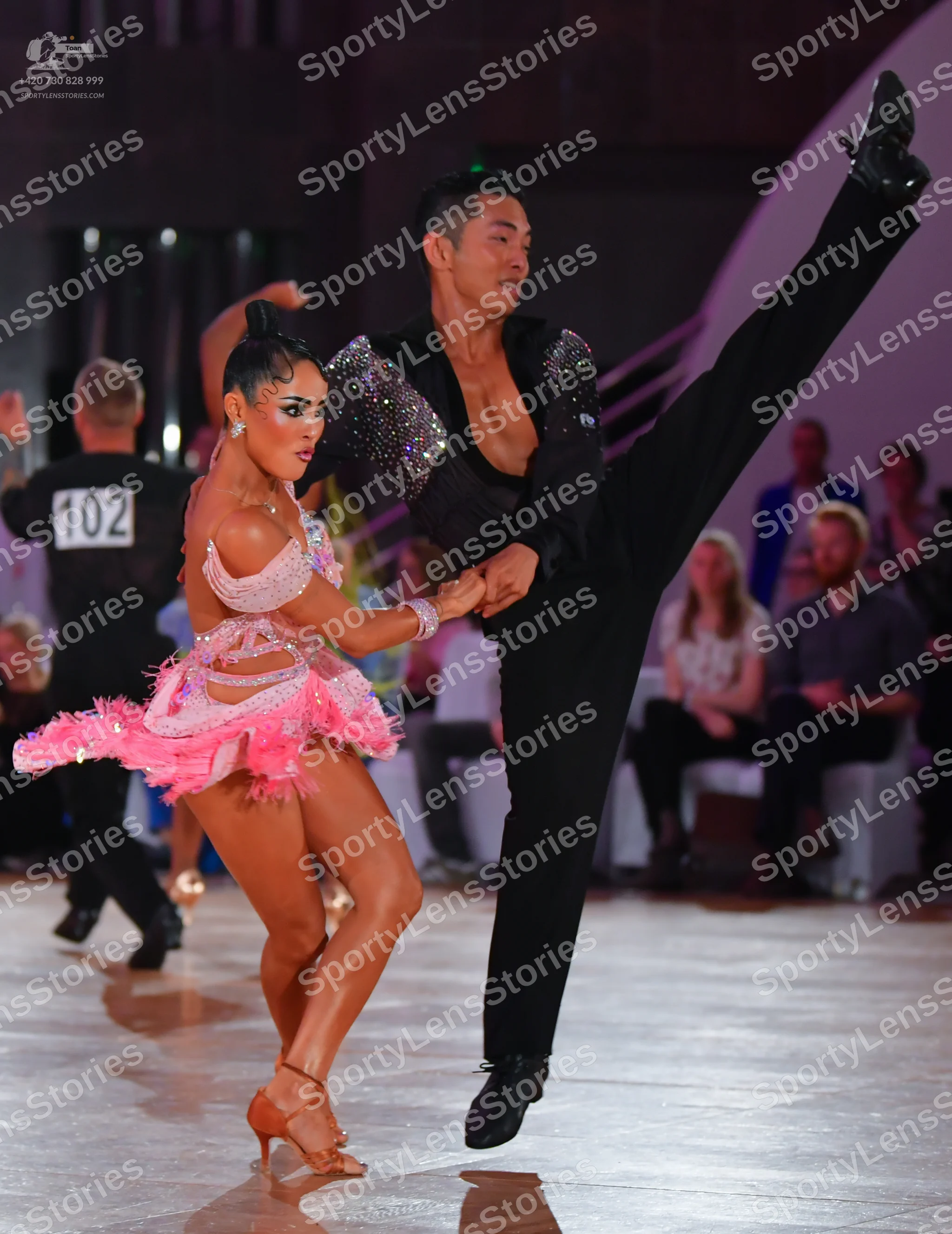Dancesport competitor #102: Male dancer: black long-sleeved shirt with large silver sequins on the shoulders