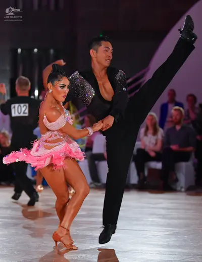 Dancesport competitor #102: Male dancer: black long-sleeved shirt with large silver sequins on the shoulders