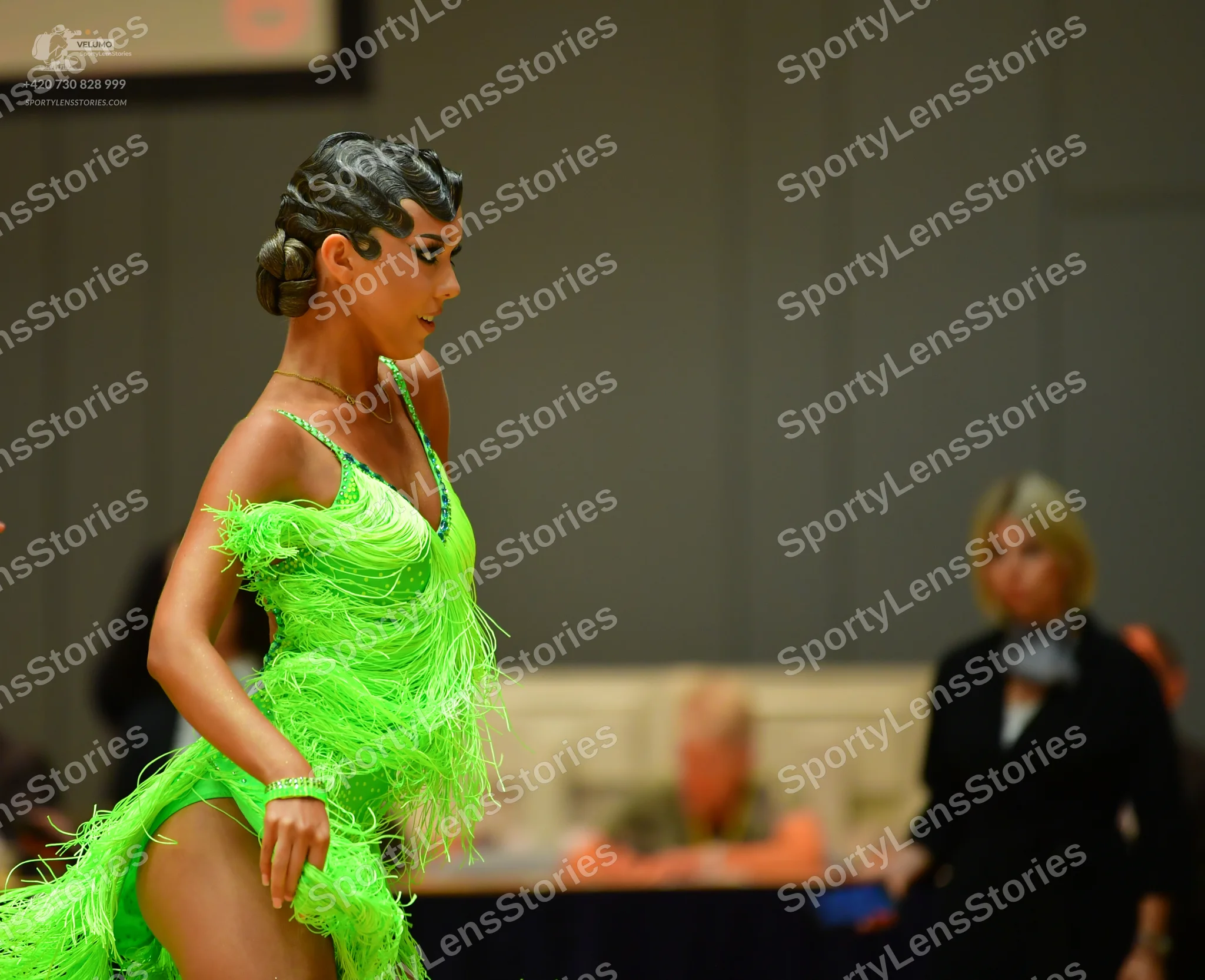 Dancesport competitor: Female dancer: lime green latin dress with fringe and thin straps