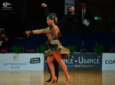 Dancesport competitor: Male dancer: black long-sleeved top and black trousers