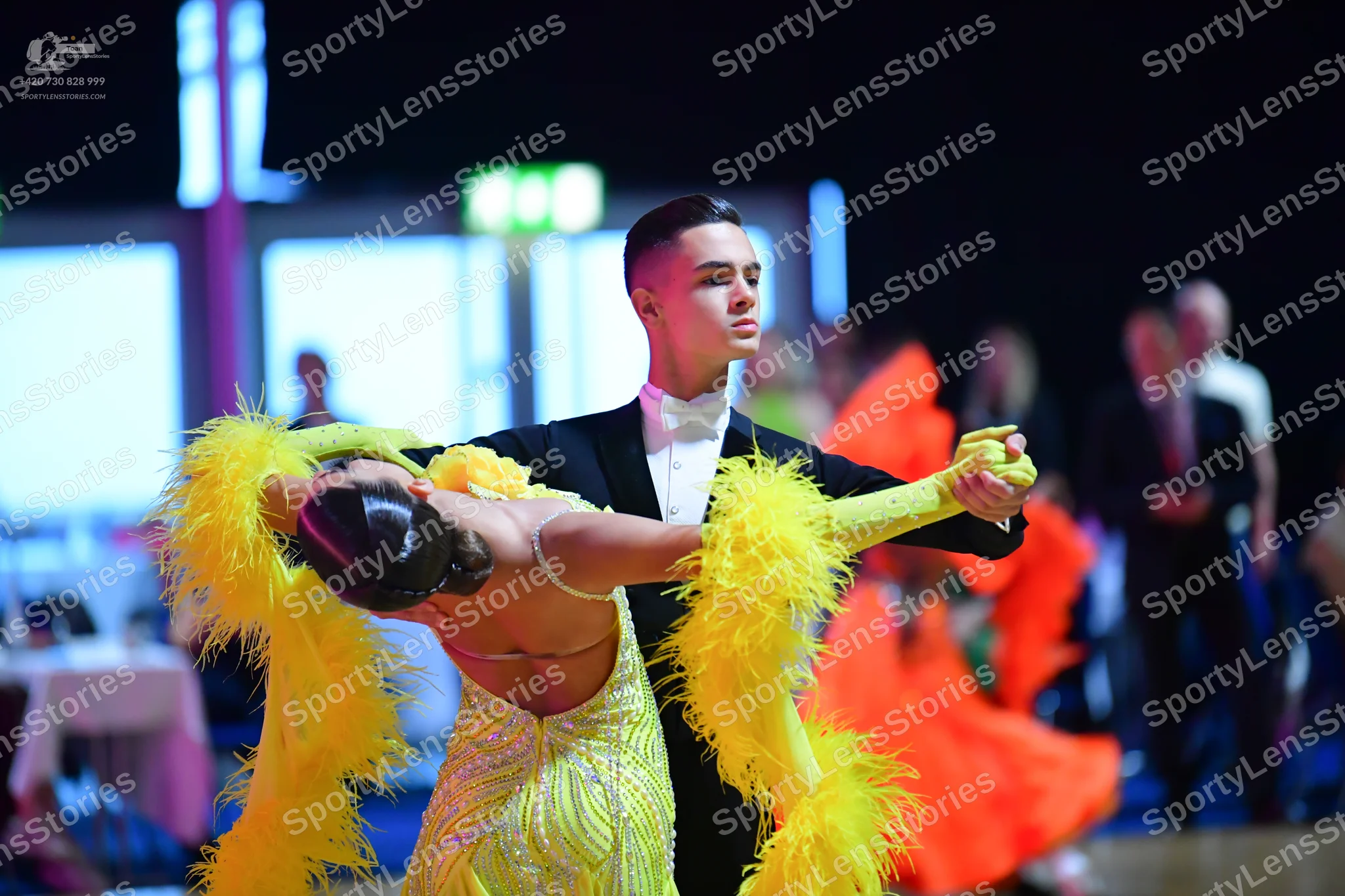 Dancesport competitor: Male dancer: black ballroom suit with a white shirt and white bowtie