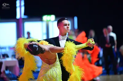Dancesport competitor: Male dancer: black ballroom suit with a white shirt and white bowtie