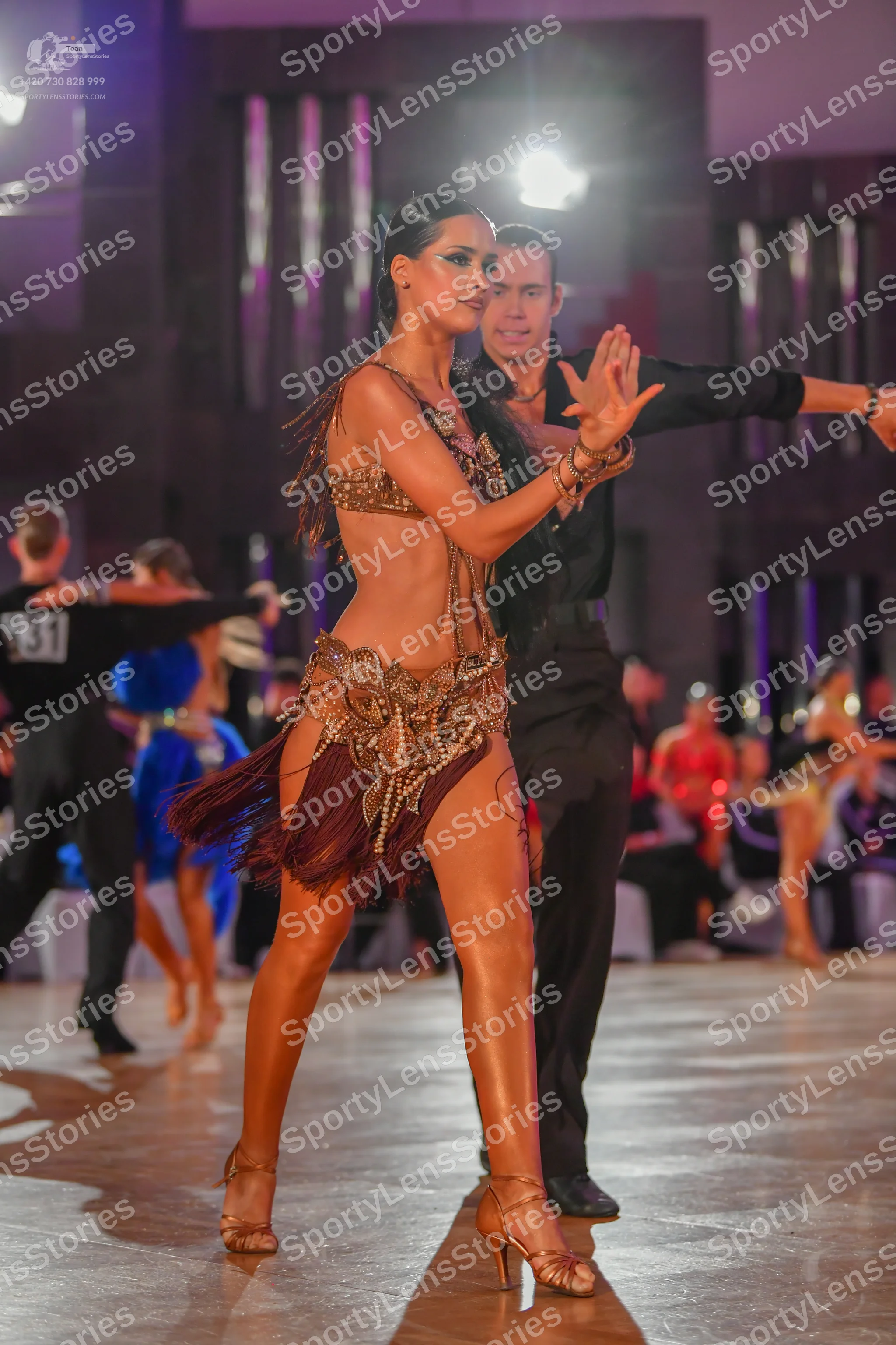 Dancesport competitor #31: Main female dancer: bronze two-piece Latin costume featuring a sequined/beaded t