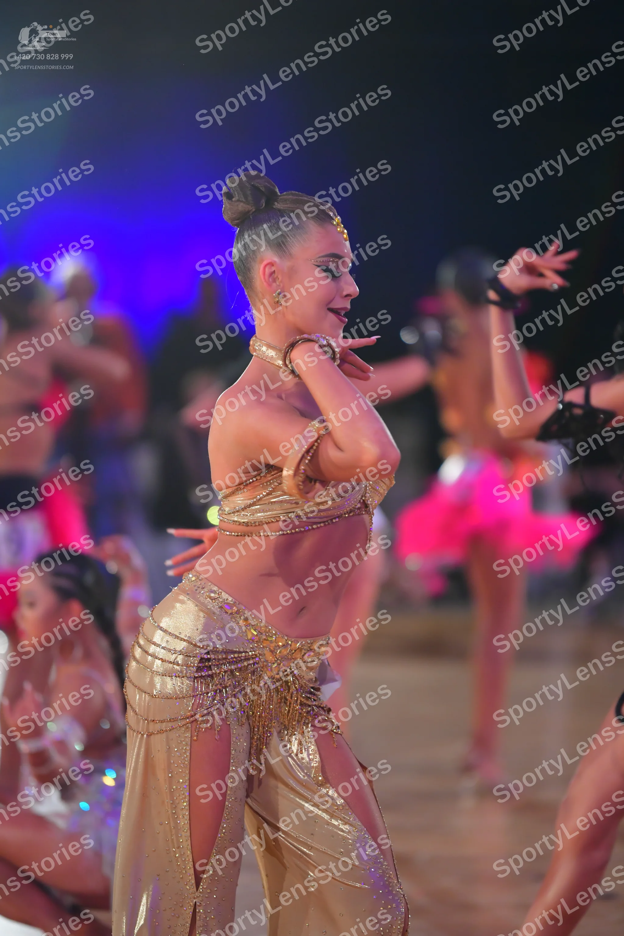 Dancesport competitor: Main female dancer: gold/champagne two-piece latin costume made of sequined fabr