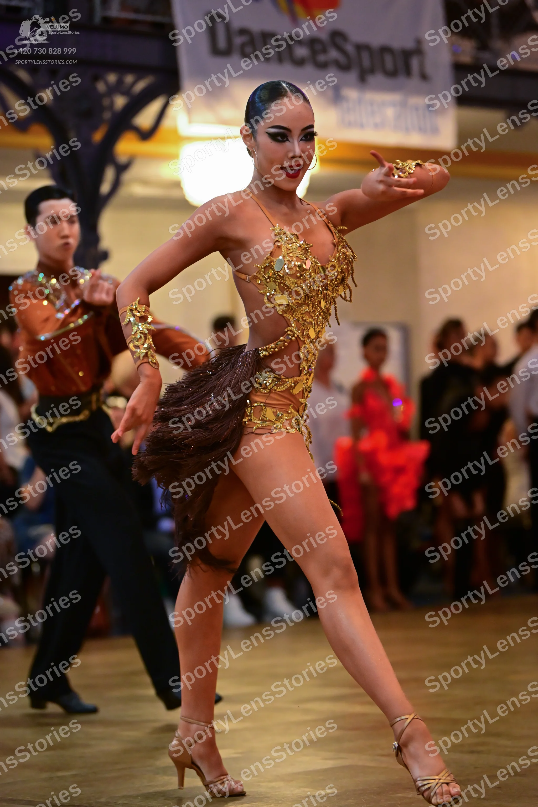 Dancesport competitor: Male dancer: copper-colored Latin dance shirt with sequin embellishments and bla
