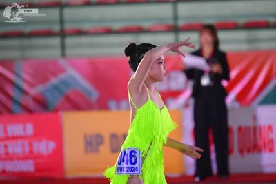 Dancesport competitor: ** Female
*   **Color:** Bright Yellow
*   **Fabric:** Shimmering, possibly sati