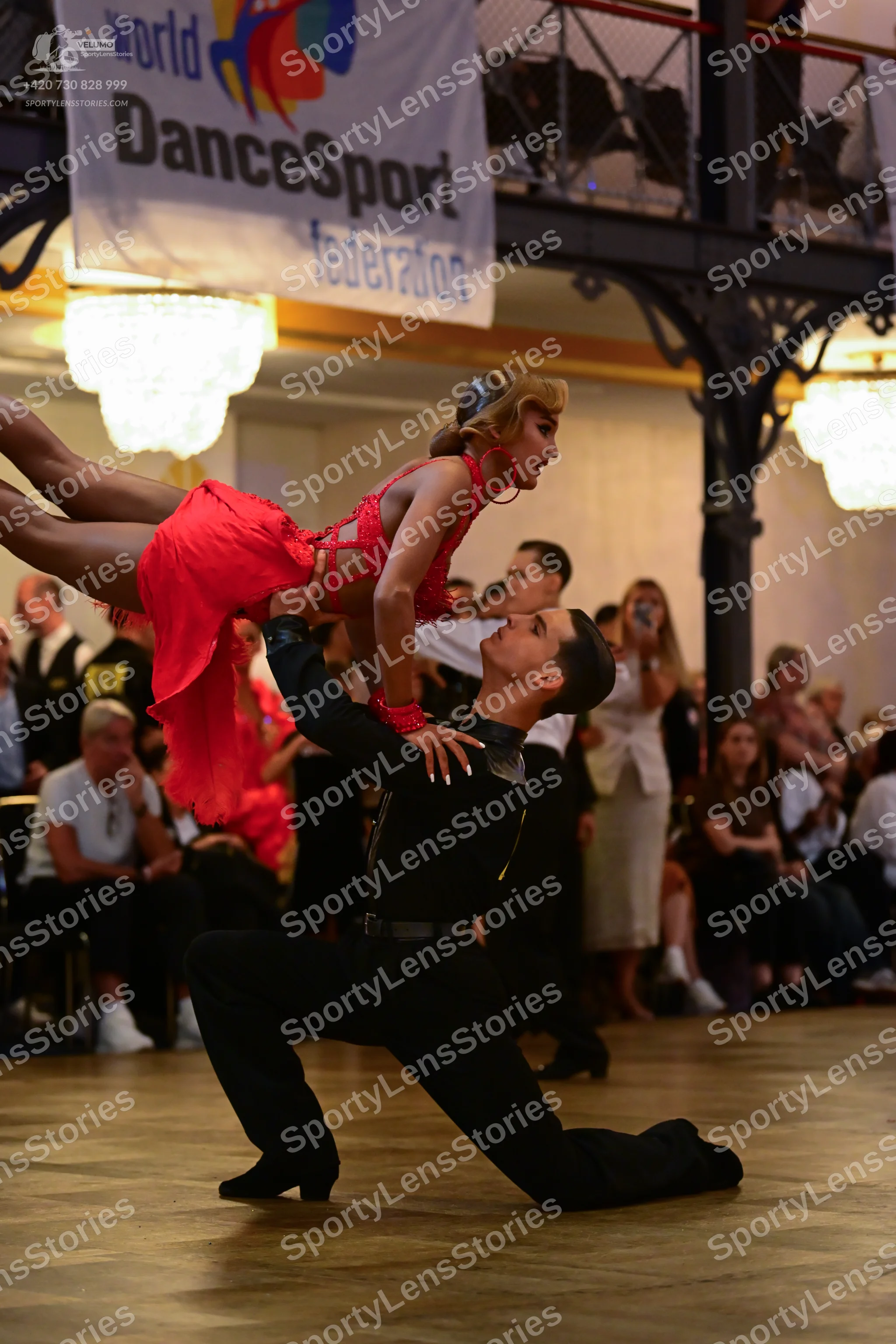 Dancesport competitor: Male dancer: black long-sleeved shirt with sequined shoulder detail and black tr