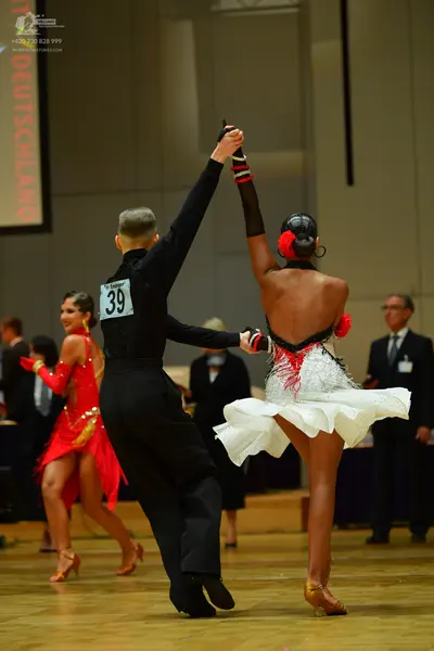Dancesport competitor: Male dancer: black long-sleeved shirt and black trousers