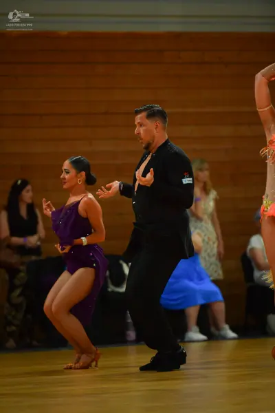 Dancesport competitor: Female dancer: purple latin dress