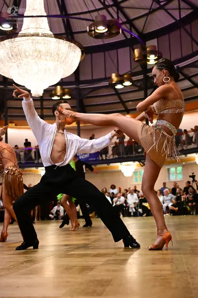 Dancesport competitor: Male dancer: white long-sleeved shirt and black trousers