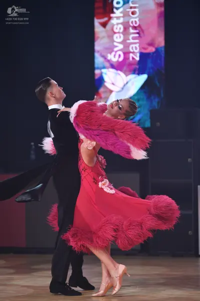 Dancesport competitor: Male dancer: black tuxedo-style suit with a white shirt and black bow tie