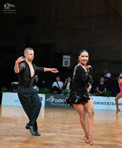 Dancesport competitor: Male dancer: black long-sleeved textured shirt and black trousers