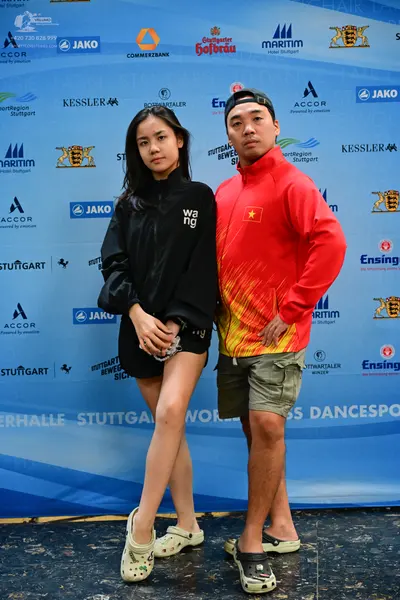 Dancesport competitor: Male dancer: orange and red gradient zip-up jacket with a small yellow star on t