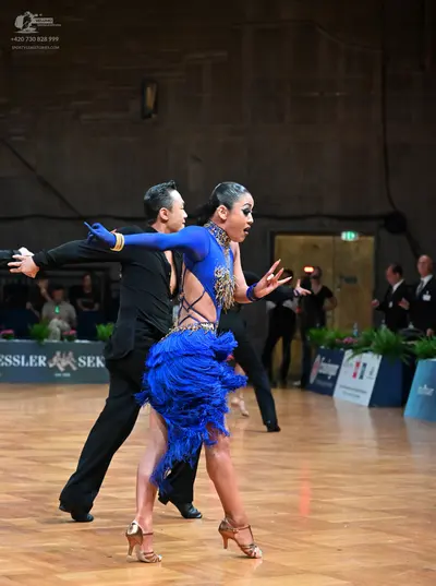 Dancesport competitor: Male dancer: black long-sleeved shirt and black trousers